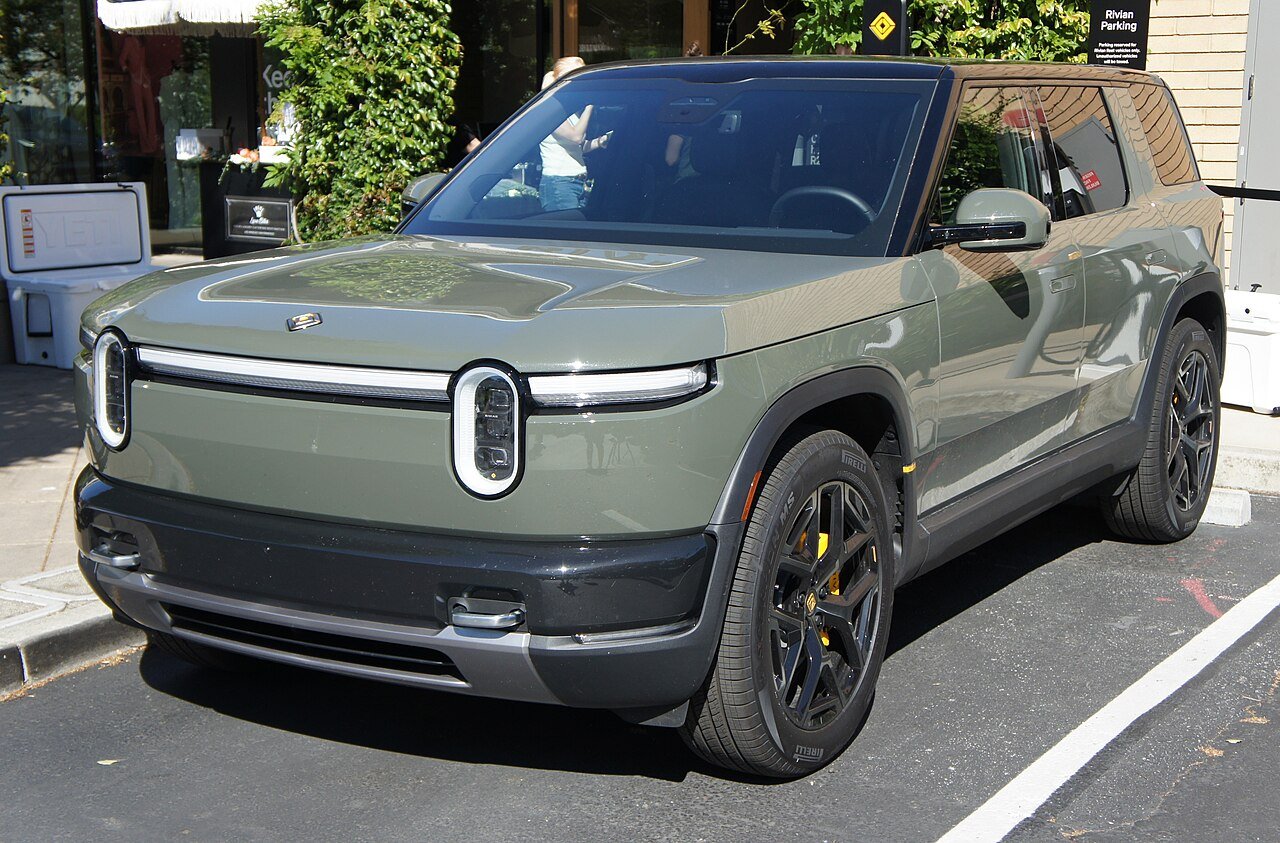 A Rivian R2 midsize electric SUV, front three-quarter view, parked outside Rivian’s store in Palo Alto, California
